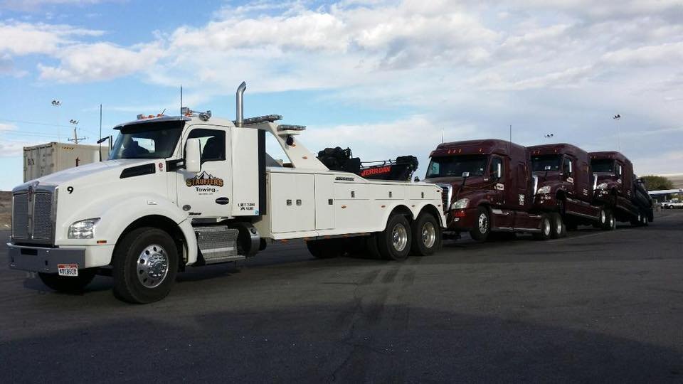 What is the difference between a tow truck and a towing device?