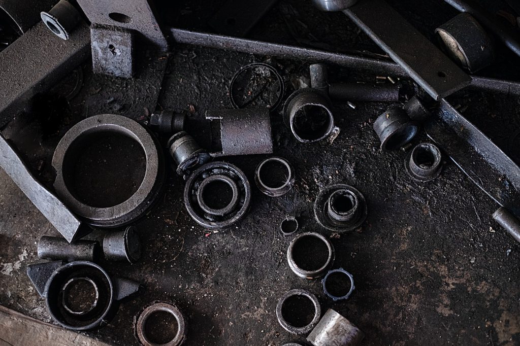 Old dirty broken auto bearings and scrap Iron on flooring