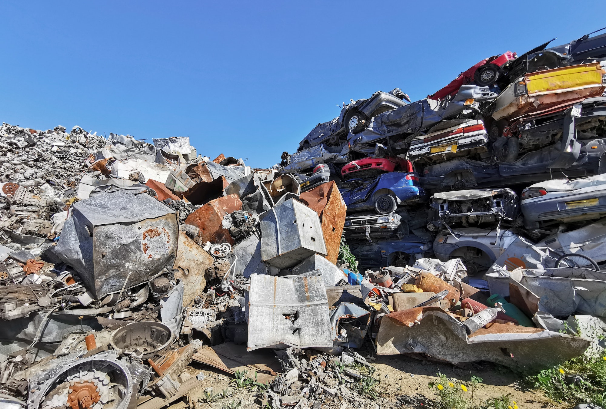 Pile of scrap cars and other metals on a junk yard ready recycling industry.